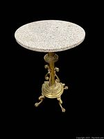 Full view of marble top and brass base with claw foot legs