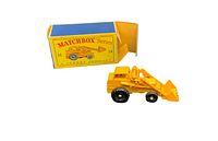 Yellow Lesney Matchbox #24 Hydraulic Excavator toy next to its original yellow and blue box with clear Matchbox branding and images.
