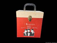 Front view showing red and cream exterior, Beatles logo, illustration, latch and handle