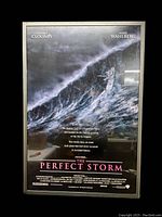 Front view of the framed Perfect Storm movie poster showing the ocean storm graphic and text with actors George Clooney and Mark Wahlberg.