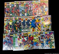 Full lot of 26 Spider-Man comic books arranged in rows, showing the colorful front covers which include Spider-Man in action and other Marvel characters.