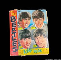 Colorful scrapbook front cover with illustrations of George Harrison, Paul McCartney, Ringo Starr, and John Lennon, titled 'The Beatles Scrap Book'.