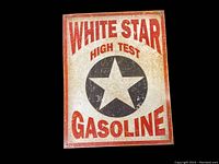 Front view of a vintage style White Star High Test Gasoline metal sign with a star logo and red lettering.