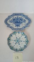 Overhead photo showing the blue and white Delft tray and the round floral dish side by side