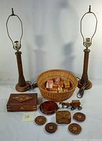 Full view showing two wooden lamps, wicker basket with stamped molds, wooden boxes, coasters and toy vehicle