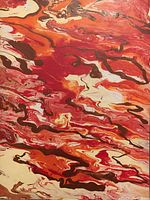 Close-up of the painting showing colorful abstract patterns in red, orange, brown, white and black resembling fire.