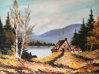 Close-up photo of painting showing a rustic house near a lake with surrounding trees and mountains in the background.