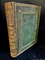 View of book full cover showing 3/4 green morocco spine with gilt tooling and marbled boards