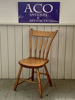 Full view of antique pine arrow back side chair showing overall design and condition.