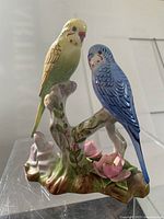 Front view of the antique bone china bird figurine showing two birds on a branch with flowers, all finely detailed and hand-painted.