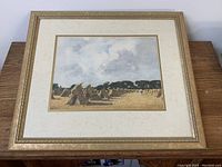 Full view of the framed watercolor painting featuring field haystacks and cloudy sky.