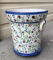 Side view of handpainted Portuguese ceramic flower pot showing floral decoration and handles.