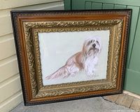 Frontal view of the framed signed pastel dog portrait, showing the detailed carving and gilding on the frame and the full image of the dog.
