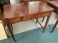 Front view of antique wood desk showing full profile and condition