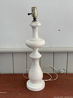 Full view of vintage alabaster marble table lamp showing its shape, base, and electrical cord with plug.