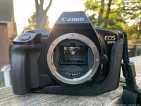 Front view showing Canon EOS 650 logo and lens mount open, displaying mirror inside camera body.