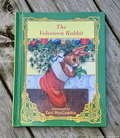 Front cover of The Velveteen Rabbit illustrated by Turi MacCombie, showing Christmas themed rabbit illustration with green and gold border.