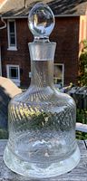Photo of vintage clear crystal decanter with ribbed, zigzag patterned glass and round stopper, showing details and condition.