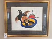 Full view of framed art print showing gold frame, mat and stylized indigenous bird artwork