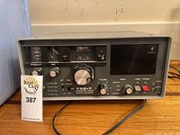 Front view of grey metal chassis receiver showing model FRG-7 front panel and controls