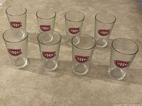 Eight clear pint glasses arranged in two rows showing the Montreal Canadiens logo on each glass.