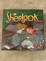 Front of the Sherlook Detective Game box showing crime scene graphics, magnifying glass, and detective tools