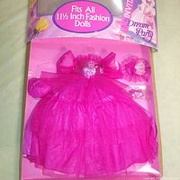 The dress and matching wrist accessory packaged flat inside original box, showing size compatibility for 11.5 inch fashion dolls and box wear.