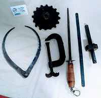 Full lot view showing all six antique/vintage tools spread out on a white cloth background