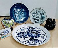 Photo showing the vintage Blue Onion, Mikasa and Andre Richard duck plate and figurine lot including a black bird figurine and small ceramic vase.
