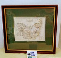 Full view of the framed map showing the wooden frame, green matting, and engraved Suffolk map by S. Hall.