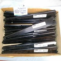 Box containing 16 black metal Rubbermaid TwinTrack shelf brackets arranged horizontally with size labels visible.