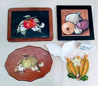Full lot showing all items: two framed painted blackboards signed by Jo Brandt, a white leaf-shaped ceramic dish, a ceramic 3D raised trivet featuring squash, and a wooden plaque painted with apples.