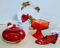 Lot displayed with all items visible including teapot, votive holders, plate, glass bowl, candle holder, and decorative shoe.