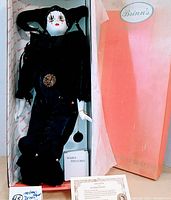 Front full view of 22" porcelain jester clown doll in original box with certificate and masks.