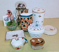 Photo of 8 small vintage collectible items including porcelain tea cup with parrot, perfume sprayer, trinket box, and decorative flower pot