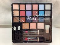 Front view of the 27-piece makeup kit showing eyeshadows, bronzer, blush, highlighter, lipsticks, applicators, and brush in tray.