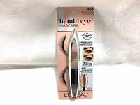 Front view of packaged L'Oreal Bambi Eye Mascara 400 Blackest Black 8.5ml in silver and pink packaging showing tube and branding.