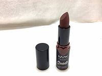 New NYX Professional Makeup Suede Matte Lipstick with the cap removed showing the lipstick bullet in a dark muted brown shade placed on a white background.