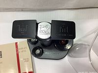 Photo showing Peugeot Epivac Duo vacuum pump with two flip-open lids labeled for wine vacuum and champagne fizz functions, Peugeot lion logo on center.