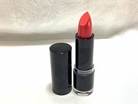 Lipstick tube, cap removed, showing bright red lipstick bullet in black casing.