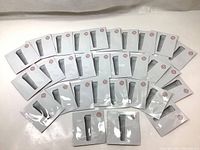Thirty individual sample sachets of Shiseido Essential Energy Eye Definer laid out in rows on a white surface