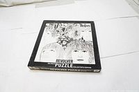 Photo of the closed puzzle box showing front artwork of The Beatles Revolver album in black and white.