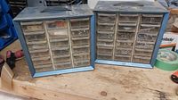 Two metal hardware cabinets with 18 clear plastic drawers each, containing assorted small metal fasteners and hardware items.