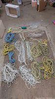 Overview photo showing multiple coils and lengths of rope in various colors and thicknesses laid out flat.