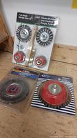 Photo of three wire brushes including a 7-piece angle grinder brush kit and two individual 150mm wire brushes with red hubs