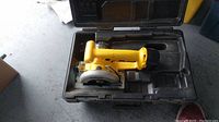 Dewalt DW930 cordless trim saw in original molded black plastic carrying case, showing compact size and yellow/black color scheme.