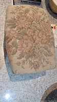 Top view showing floral patterned fabric upholstery on the stool