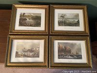 Four reproduction prints framed in gold-tone ornate frames arranged on a table, showing all four scenic Canadian historical scenes.