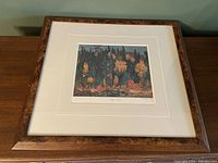 Framed overall view of the signed limited edition print showing the wood frame and white mat around the print.