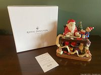 Image showing the figurine with Santa Claus and elf, original Royal Doulton box and certificate.
